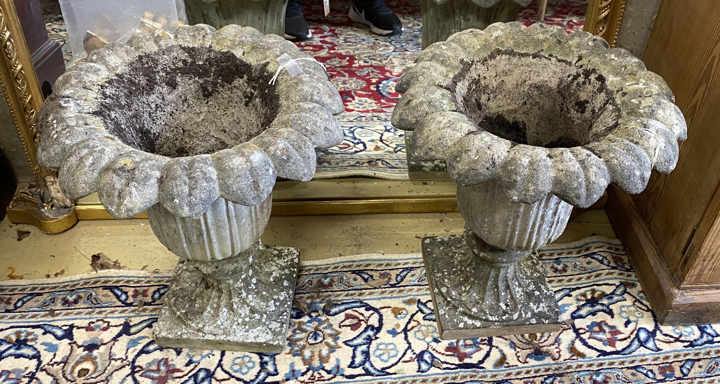 A pair of reconstituted stone campana garden urns on bases, diameter 42cm, height 46cm